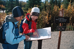 Denali National Park Visitors check out a trail map